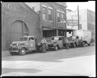 F.F. Sales Corporation, 440 West Vine; building; exterior; three                             men standing next to trucks parking in front of building