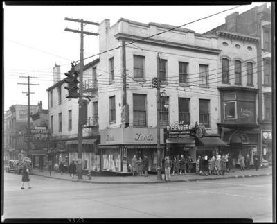 Leed’s, 100-101 West Main; street view, corner of South Limestone                             and West Main; Phil Rosenberg Jeweler, 102 West Main; Runyon Candy Shop,                             104 West Main; Darling Shops (Women's wear), 106 West Main;                             Wing's Chop Suey, 105 1/2 South Limestone