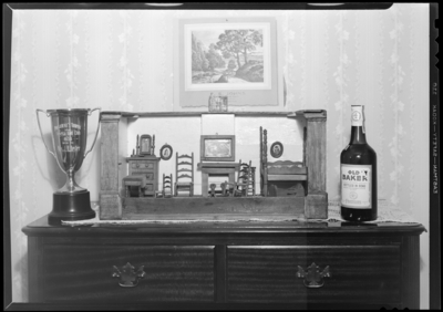 Theodore Moore; Chevy Chase Apartments (865 Tates Creek Pike);                             interior; dollhouse, golf trophy, and bottle of whiskey on top of bureau                             (dresser)