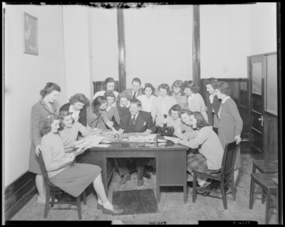Georgetown College; group gathered around a desk