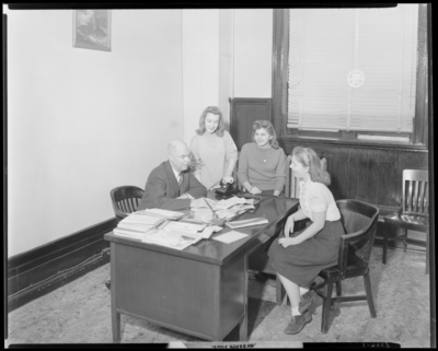 Georgetown College; group gathered around a desk