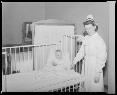 Good Samaritan Hospital, 310-330 South Limestone; nurses standing                             beside a baby in bed