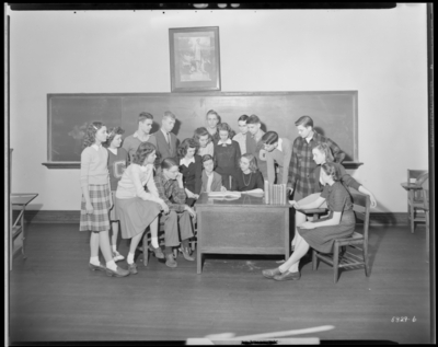 Speak Club, Garth High School (Georgetown); interior; group                             gathered around a desk