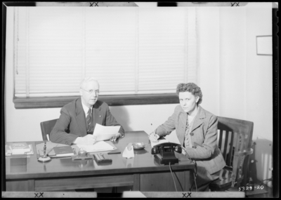 Superintendent's Office (Principal) , Garth High School                             (Georgetown); interior; man sitting at desk, woman taking notes                             (dictation)