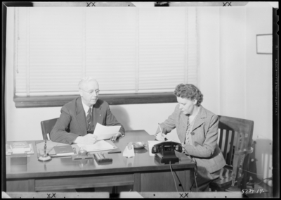 Superintendent's Office (Principal) , Garth High School                             (Georgetown); interior; man sitting at desk, woman taking notes                             (dictation)