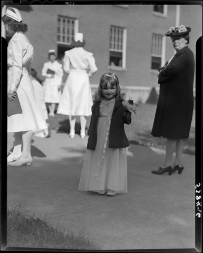 St. Joseph's Hospital, 544 West Second (2nd) Street; Cadet                             Nurses (graduation); exterior; young girl holding flowers standing next                             to nurses and attendees