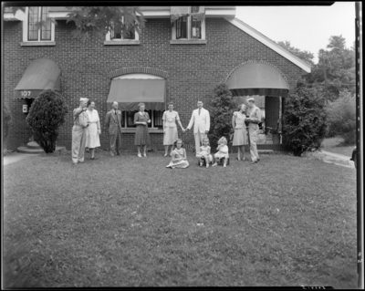 J. R. Nunnely; (107 Suburban Court); exterior; family members                             standing on the lawn (grass); group portrait