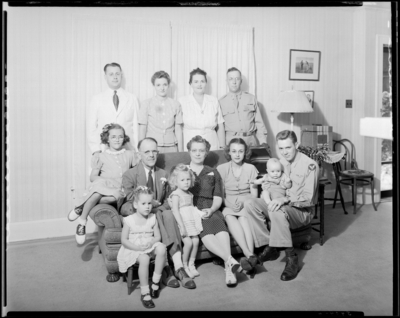 J. R. Nunnely; (107 Suburban Court); interior; family members                             sitting on the couch (sofa); group portrait