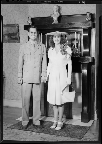 Lucille Innis; (600 Woodland); wedding; interior; man and woman                             standing in front of a fireplace