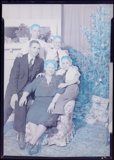 Mrs. W. R. Pickett; family members gathered next to Christmas                             tree; group portrait
