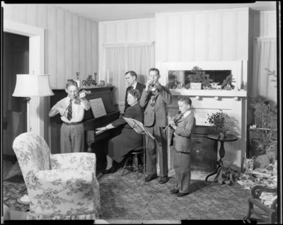 Mrs. W. R. Pickett; mother and children playing musical                             instruments while father watches