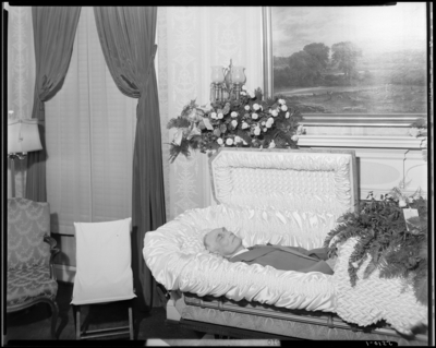 T.Z. Steward; corpse; open casket surrounded by                             flowers