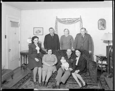 M.L.S. Ford; (310 Cocran); family members, four (4) generations;                             interior; family members gathered around couch (sofa); group                             portrait