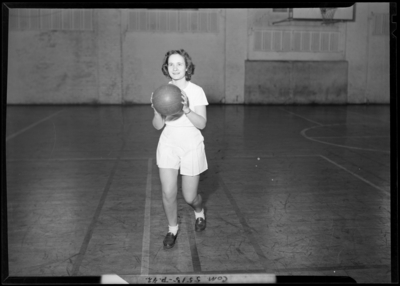 Georgetown College; gym (gymnasium); interior; woman with                             basketball