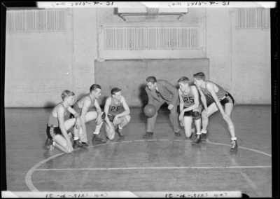 Georgetown College; Men's basketball; gym (gymnasium);                             interior; coach huddled with players
