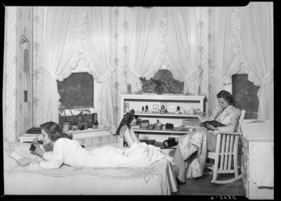 Georgetown College; dorm room; interior; woman lounging on bed;                             woman sitting in rocking chair