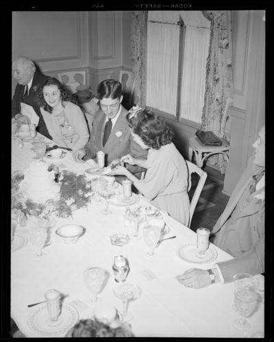 Mr. & Mrs. Pat Mullendore (Mullendare); wedding;                             reception; interior; wedding couple and guests gathered around banquet                             table