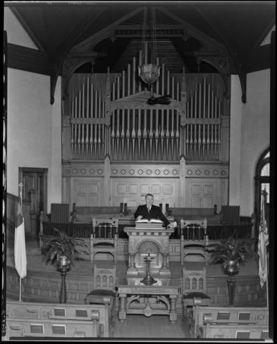 Georgetown Christian Church; interior; alter and pipe organ; man                             standing at the pulpit