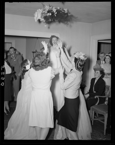 Mr. & Mrs. Richard Wall; wedding; interior; bride                             throwing the bouquet