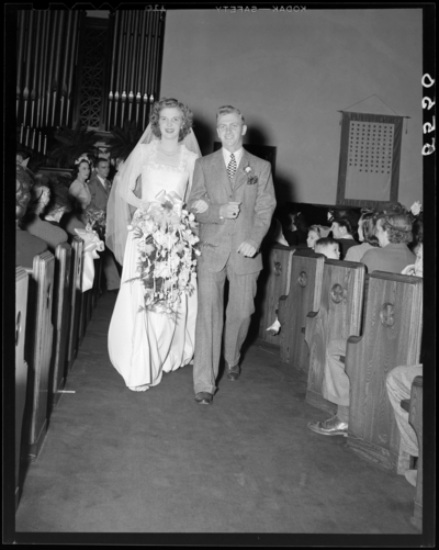 Mr. & Mrs. Richard Wall; wedding; interior; wedding                             couple (bride and groom) walking down the isle