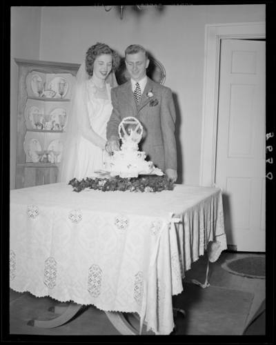 Mr. & Mrs. Richard Wall; wedding; interior; wedding                             couple (bride and groom) cutting wedding cake