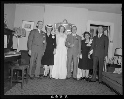 Mr. & Mrs. Richard Wall; wedding; interior; wedding                             couple (bride and groom) standing with guests; group                             portrait