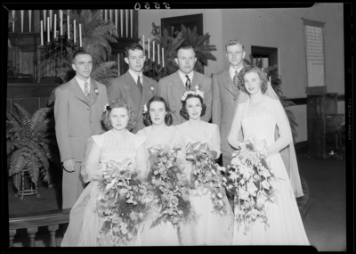 Mr. & Mrs. Richard Wall; wedding; interior; wedding                             couple (bride and groom) standing with the bridesmaids and best                             men