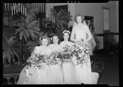 Mr. & Mrs. Richard Wall; wedding; interior; bride                             standing besides the bridesmaids; group portrait