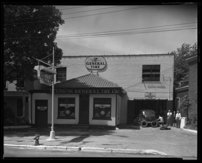 Lexington General Tire Company, 254 East Main; building;                             exterior; group standing next to car; workers changing car                             tires