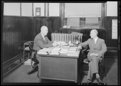 Georgetown College; interior; two men sitting at a                             desk