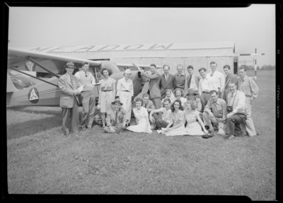 Lieutenant Colonel Coconougher; airport; group portrait in front                             of airplane