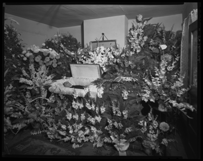 Kerman Holman; corpse; open casket surrounded by                             flowers