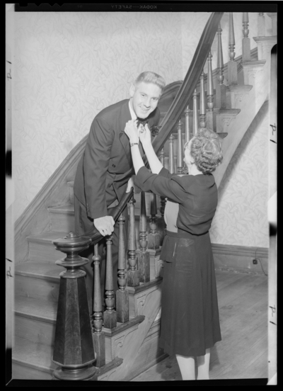 Georgetown College; Bill Jones; interior; woman adjusting a                             man's tie