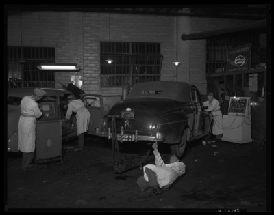 Taylor Tire Company, East Vine and Southeastern Avenue; interior;                             service bays; workers servicing cars