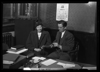 Georgetown College; Belle of the Blue; interior; office; man and                             women sitting next to a desk