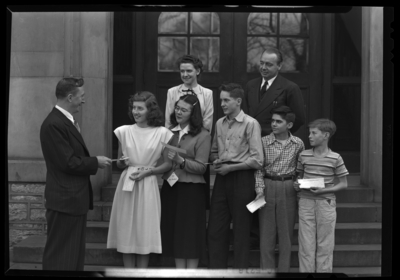 Kentucky Fire Prevention Association; Lexington Junior High;                             exterior; man handing a group of children awards?; group                             portrait