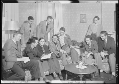Georgetown College; Pauling Hall; interior; group of men gathered                             around the lounge