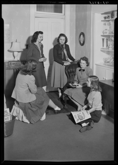 Georgetown College; interior; group of women gathered around a                             chair