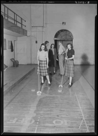 Georgetown College; interior; group playing                             shuffleboard