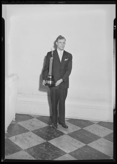 Georgetown College; man standing with trophy