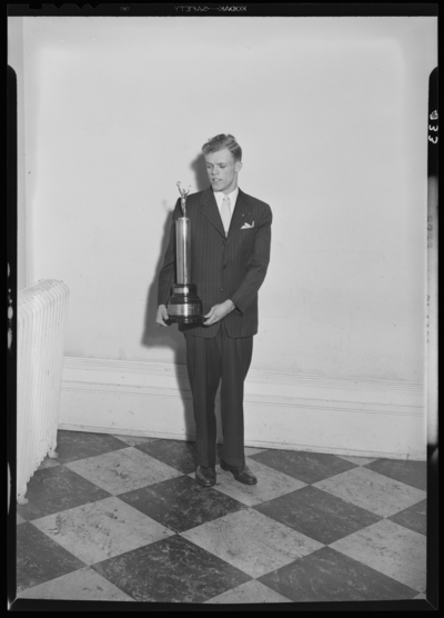 Georgetown College; man standing with trophy
