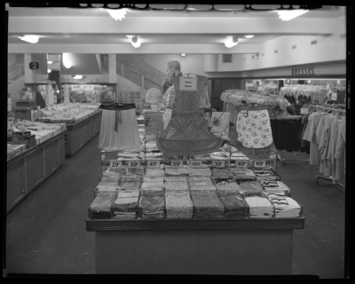 S.S. Kresge & Company (156, 250 West Main); plastic                             apron, tablecloth displays