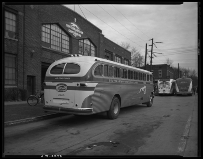 Southeastern Greyhound Lines; bus parked outside of                             garage