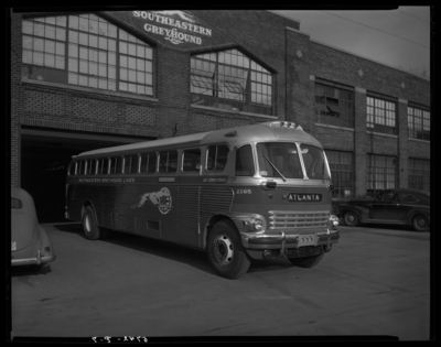 Southeastern Greyhound Lines; bus parked outside of                             garage