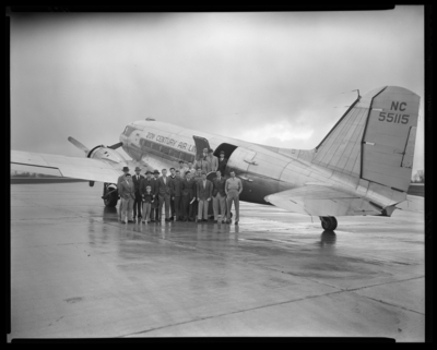 University of Kentucky Basketball Team; 1946-47; airport,                             All-American Tours; team standing outside of airplane