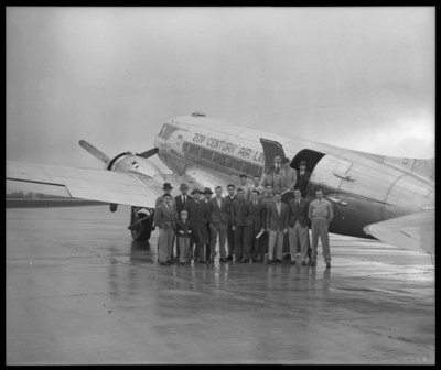 University of Kentucky Basketball Team; 1946-47; airport,                             All-American Tours; team standing outside of airplane