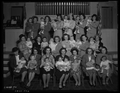Methodist Christian Church; interior; seated women holding                             babies