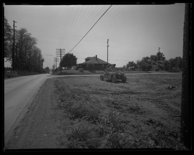 George Hoskins, 611-621 East Third (3rd); farm machine in open                             field