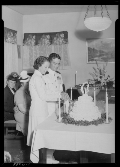 Mr. & Mrs. Knox Buchanon; 1054 Duncan; wedding party;                             interior; bride and groom cutting wedding cake