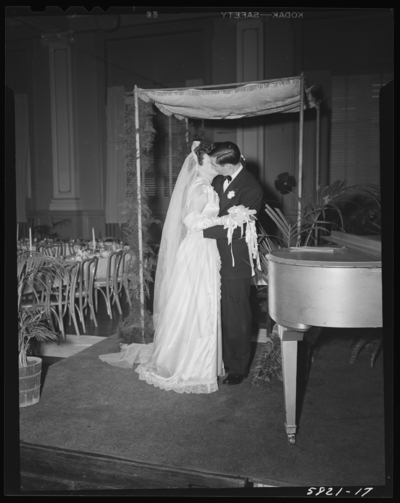Mr. & Mrs. Jack Pywen; wedding; interior; bride and groom                             kissing
